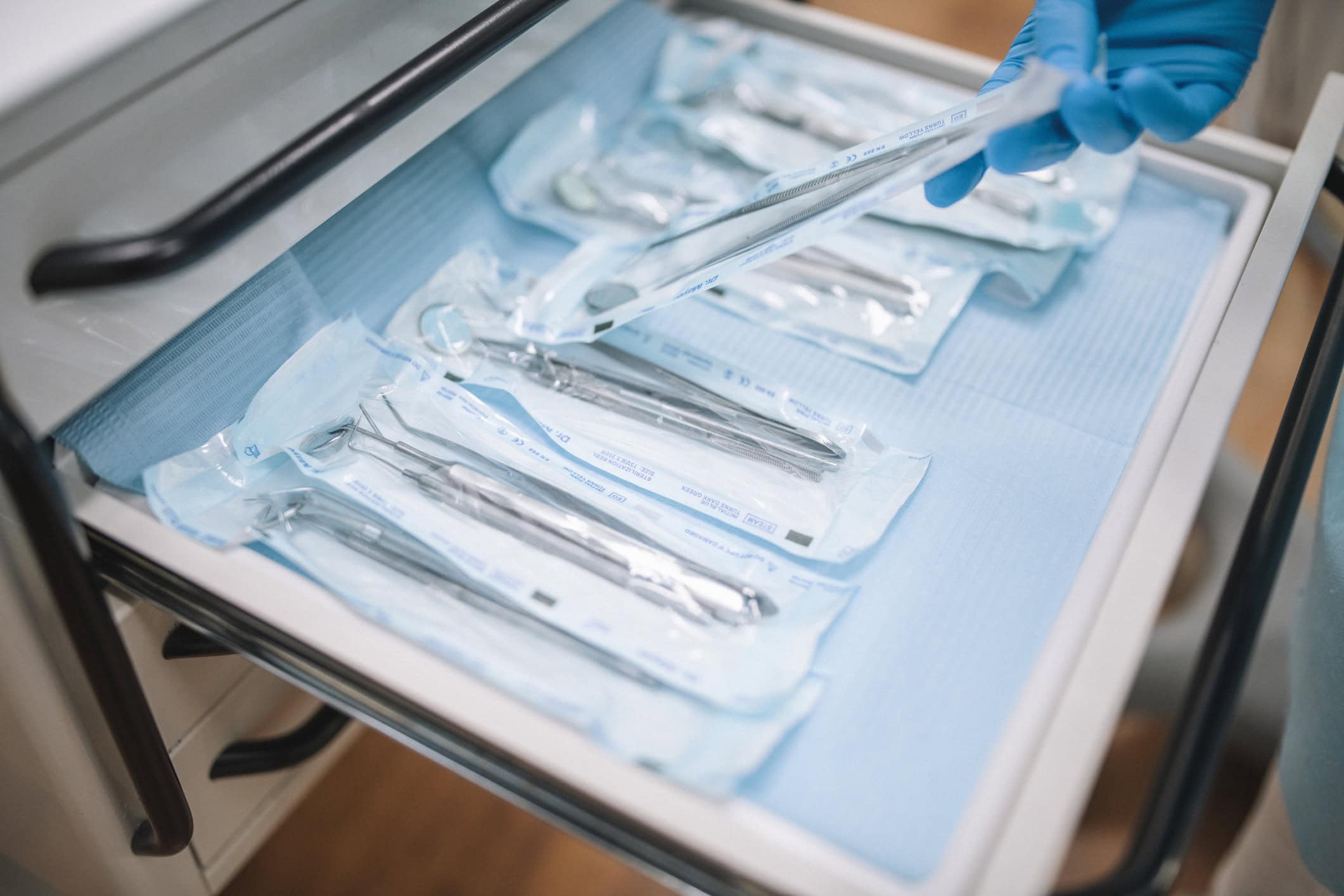 Organising dental tools in studio A dentist organizing dental equipment in cabinet