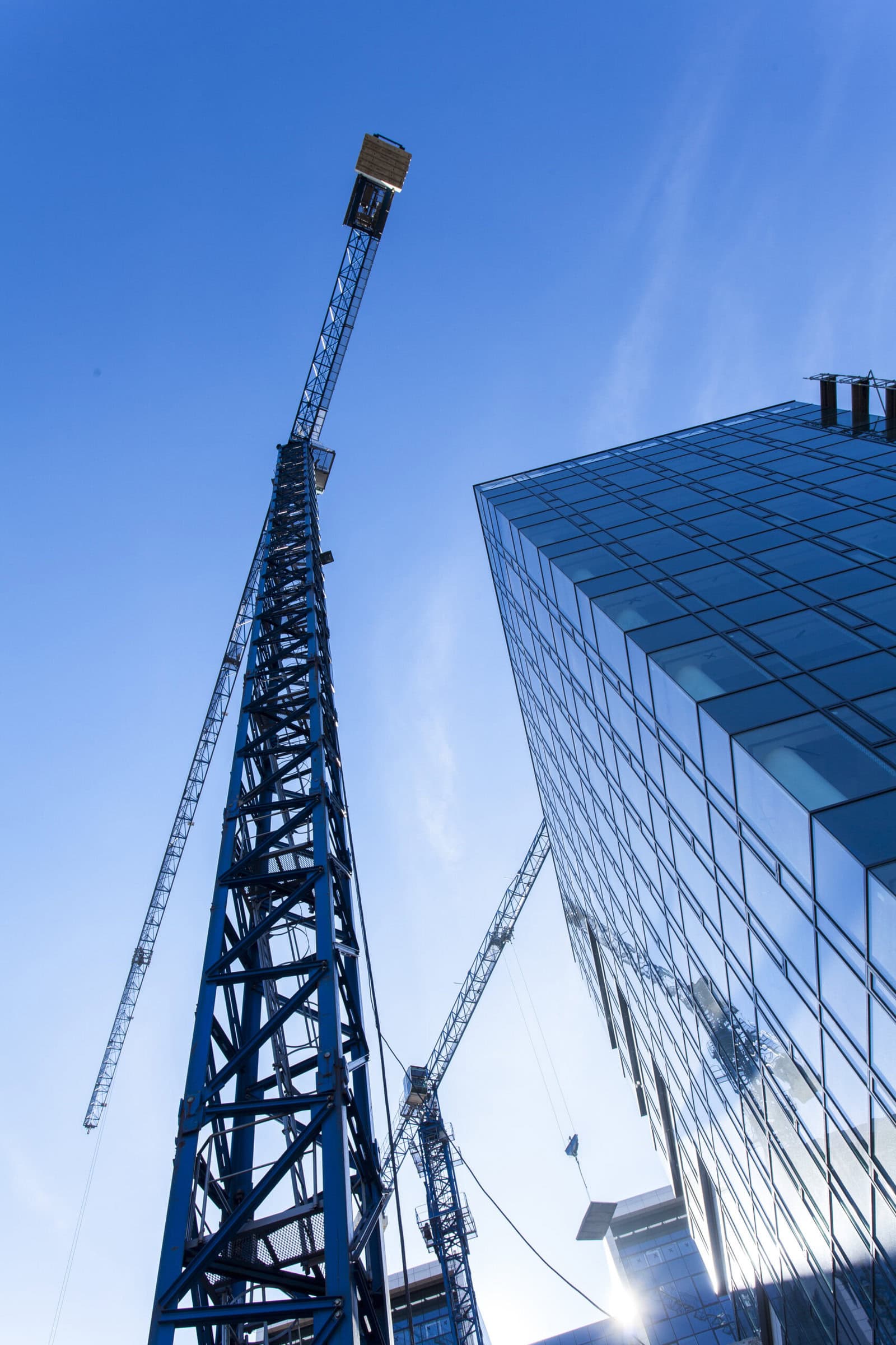 Building,Construction,Site,Detail Exterior of a tall building with a construction crane