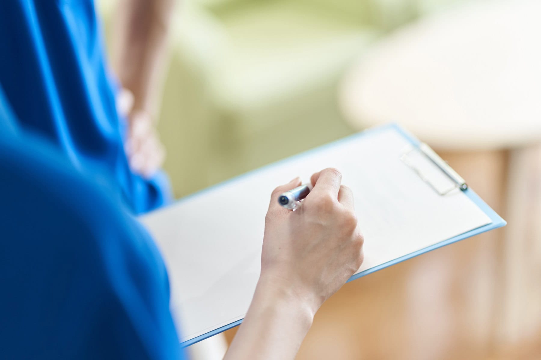 View,Materials,With,Binder,Caregiver's,Hand Medical professional holding a clipboard
